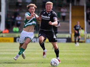 Yeovil Town striker Harvey Greenslade tussles for the ball against a Bristol Rovers player.