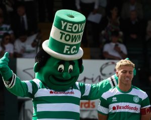 The Jolly Green Giant gives a big thumbs up alongside a smiling Jake Wannell ahead of kick-off.