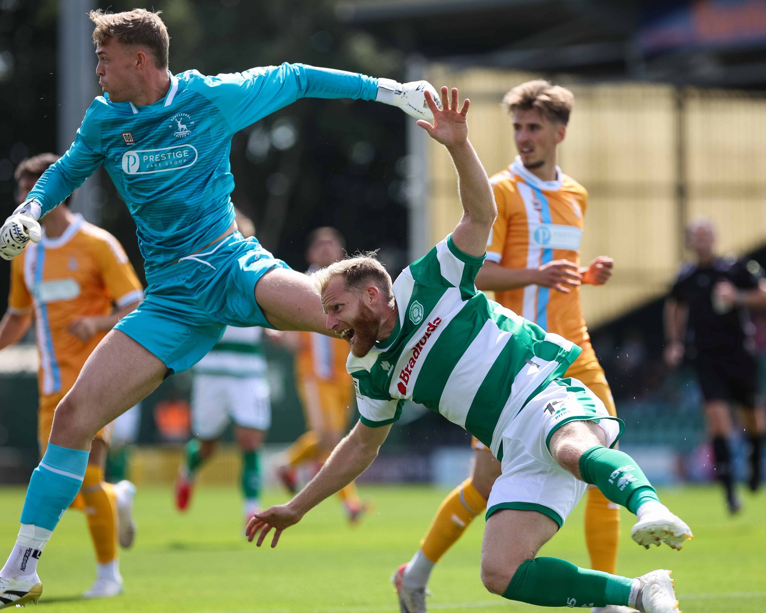 Josh Sims goes down under pressure from the goalkeeper.