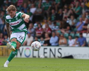 Charlie Cooper strikes the ball.