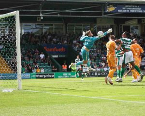 Yeovil Town striker Tahvon Campbell cannot quite connect with a cross as Hartlepool keeper Harvey Cartwright misses his punch.
