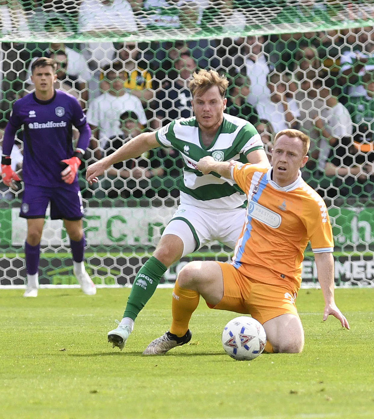 Alex Whittle grapples with a Hartlepool United player.