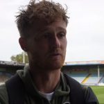 Defender Joe Gubbins speaks at pitchside after the 1-1 draw with Scunthorpe United.