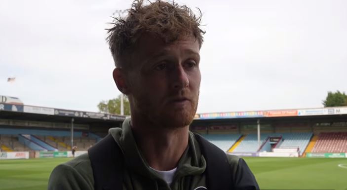 Defender Joe Gubbins speaks at pitchside after the 1-1 draw with Scunthorpe United.